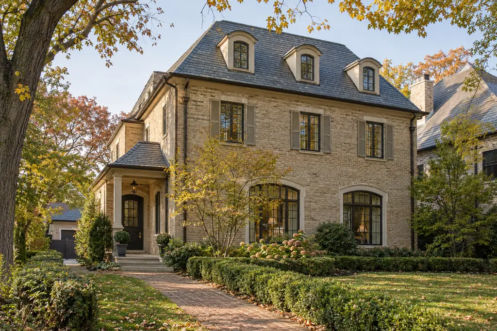French provincial stone home with a brick walk in East Lake Forest, IL