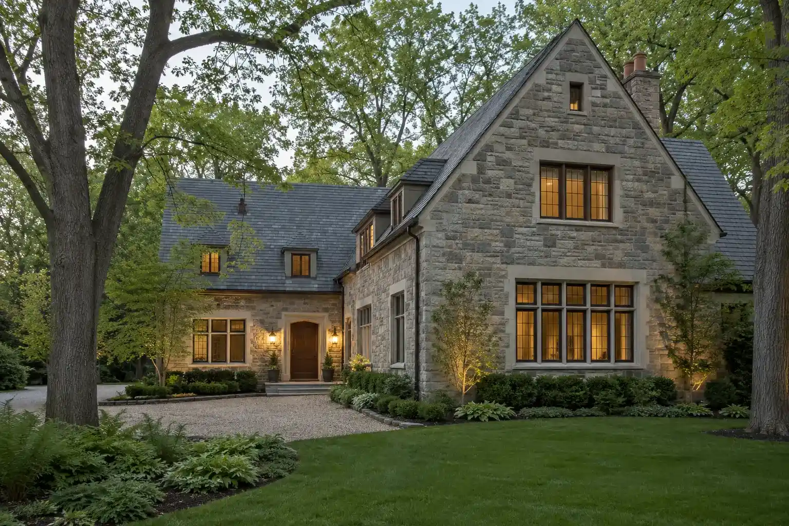 Stone Tudor home with slate gables behind fall oaks, from Realtor in Lake Forest, IL