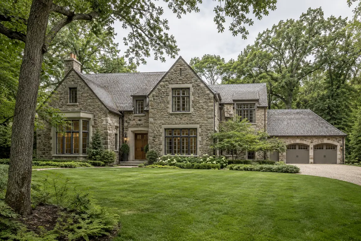 Stone estate with a three-car garage and a wide lawn in Villa Turicum, Lake Forest